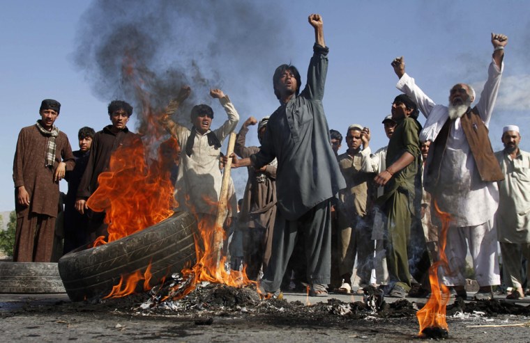 Image: Afghans burn tires during a protest