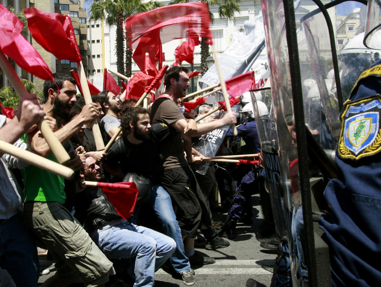 Image: Protesters clash with policemen during riots at a May Day rally in Athens