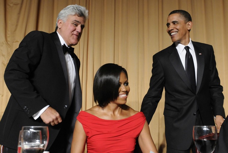 Image: U.S. President Obama and Leno smile as they help Michelle Obama with her chair at White House Correspondents' Association Dinner in Washington