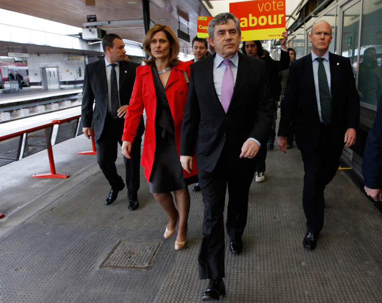 Image: Britain's Prime Minister Brown and his wife Sarah walk through Coventry station