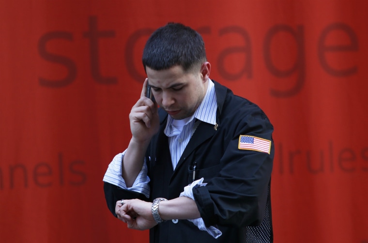 Image: A trader talks on his mobile phone outside of the New York Stock Exchange in New York