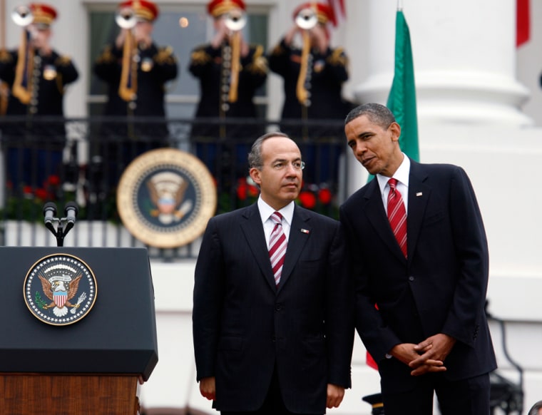 Image: U.S. President Obama and Mexican President Calderon talk during the official arrival ceremony at the White House in Washington