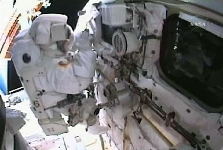 Image: Astronaut Garrett Reisman waves to crewmembers on the aft flight deck of the Space Shuttle Atlantis.