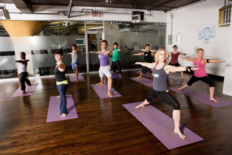 Image: A class posing in a hot yoga room