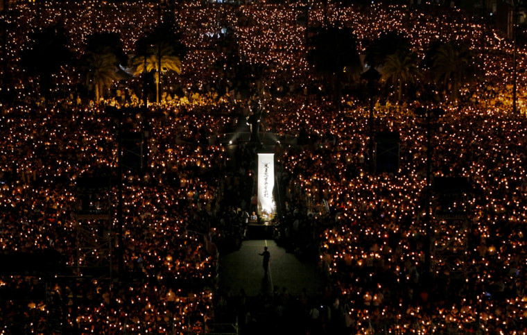 Image: Tens of thousands of people attend a candlelight vigil at Hong Kong's Victoria Park