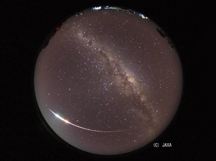 A fish-eye view of the night sky over Australia, provided by the Japan Aerospace and Exploration Agency, shows the fireball created by the Hayabusa probe's atmospheric re-entry late Sunday.