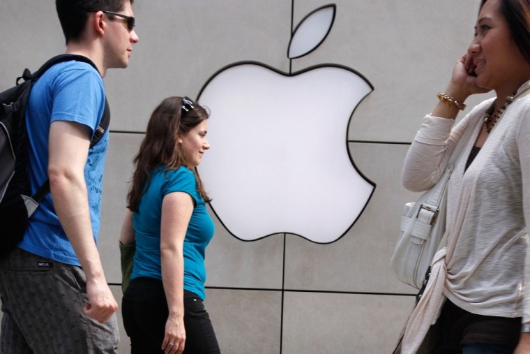 Image: Pedestrians walk past an Apple retail store in Chicago