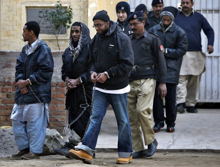 Image: Detained American are escorted by police officers in Sargodha, Pakistan