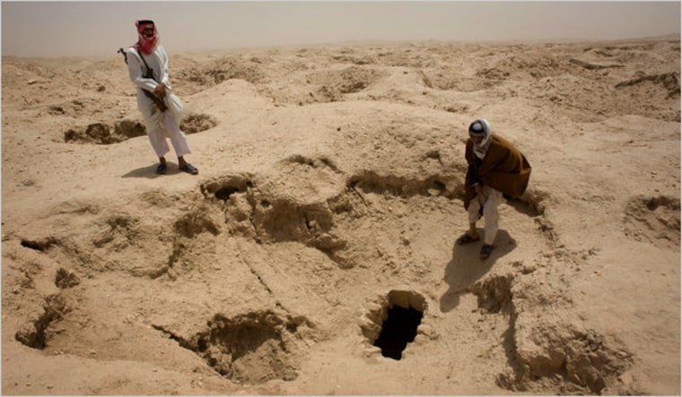 Local Bedouin tribesmen at a looted Sumerian tomb, one of hundreds of illegal digging sites at an ancient Sumerian city buried near the Iraqi village of Dhahir. 