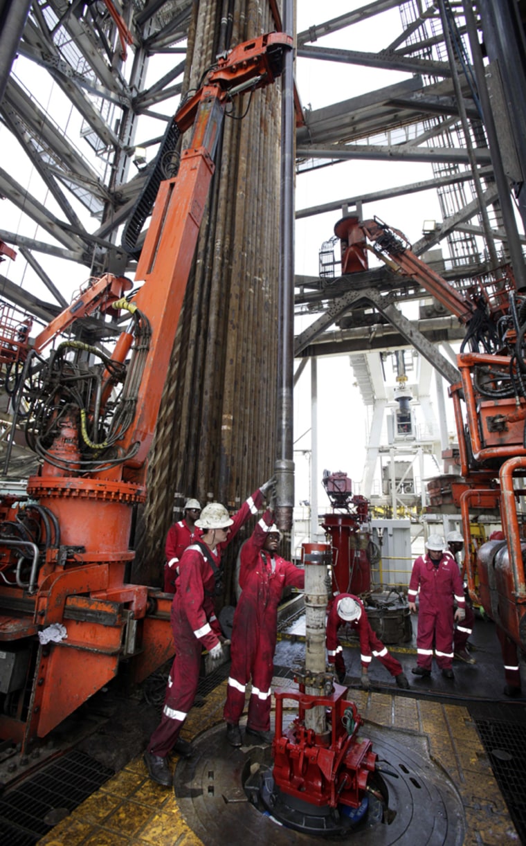 Image: Workers are seen on the drill floor of the Development Driller II