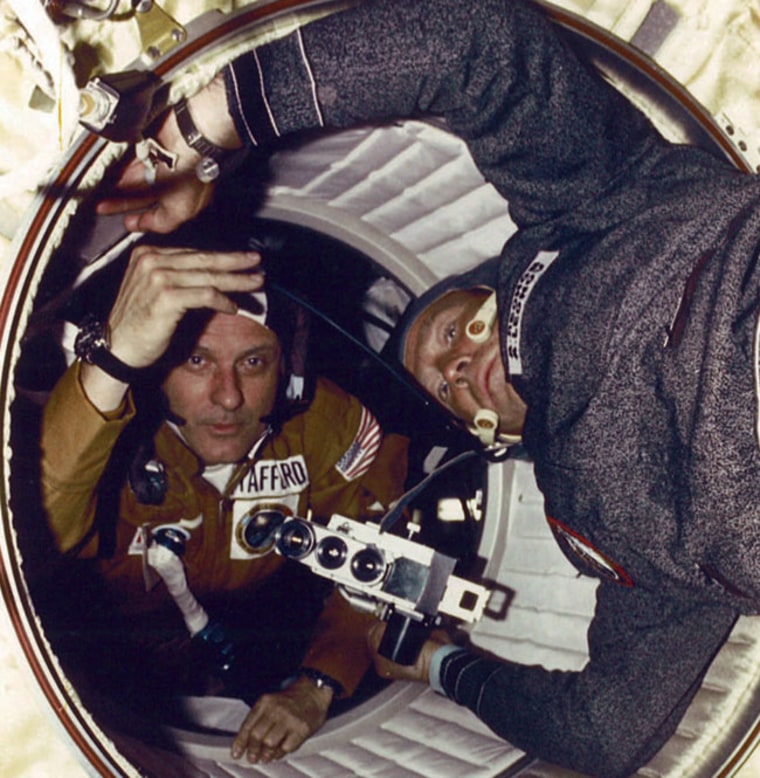 American astronaut Thomas Stafford (left) and Soviet cosmonaut Alexei Leonov greet each other after opening the hatches between their Apollo and Soyuz spacecraft in 1975.