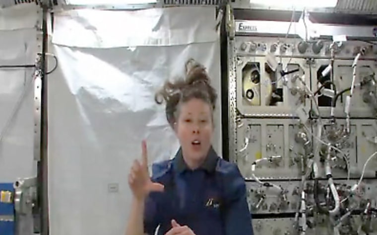 In this still from a NASA video, NASA astronaut Tracy Caldwell Dyson signs to deaf students, in the first sign language address from the International Space Station. 