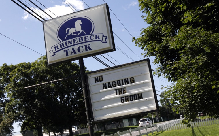 Image: A message is seen on a sign at Rhinebeck tack, a horse riding equipment shop in Rhinebeck, New York