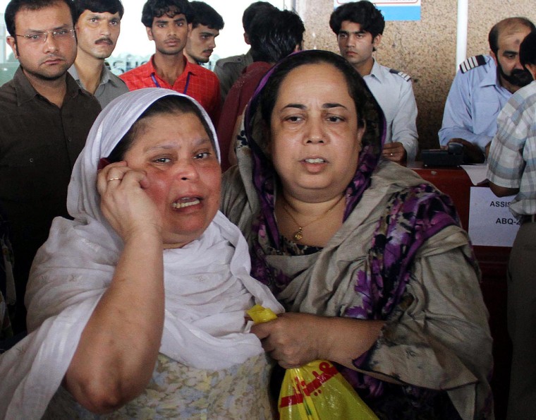 Image: Relatives gather at Jinnah International Airport