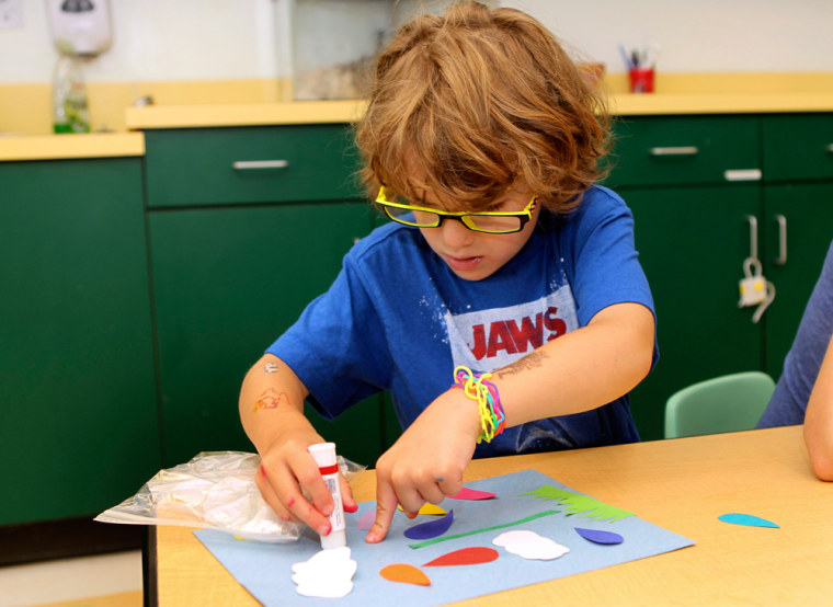 Image: A prekindergarten student works on an art project at the Walden Early Childhood Center