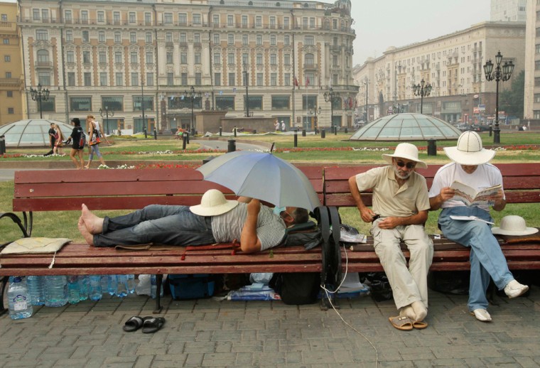 Image: People rest on the Manezhaya Square just outside the Moscow Kremlin,