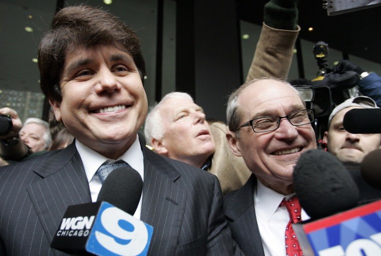 Image: File photo of Blagojevich smiling as he and his attorney leave federal court in Chicago