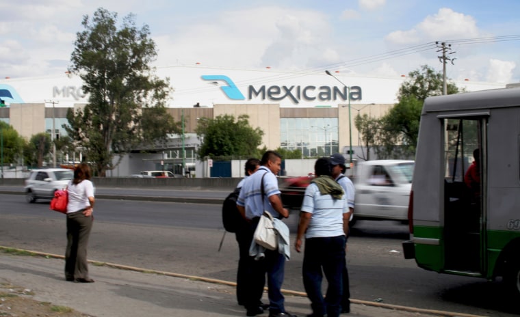 Employees of Mexicana, a large airplane maintenance facility at the Mexico City International Airport, prepare to go to work this June. In addition to working on Mexicana Airlines planes, workers do heavy maintenance work on U.S. passenger jets. (Photo by Stevie Mathieu/News21)