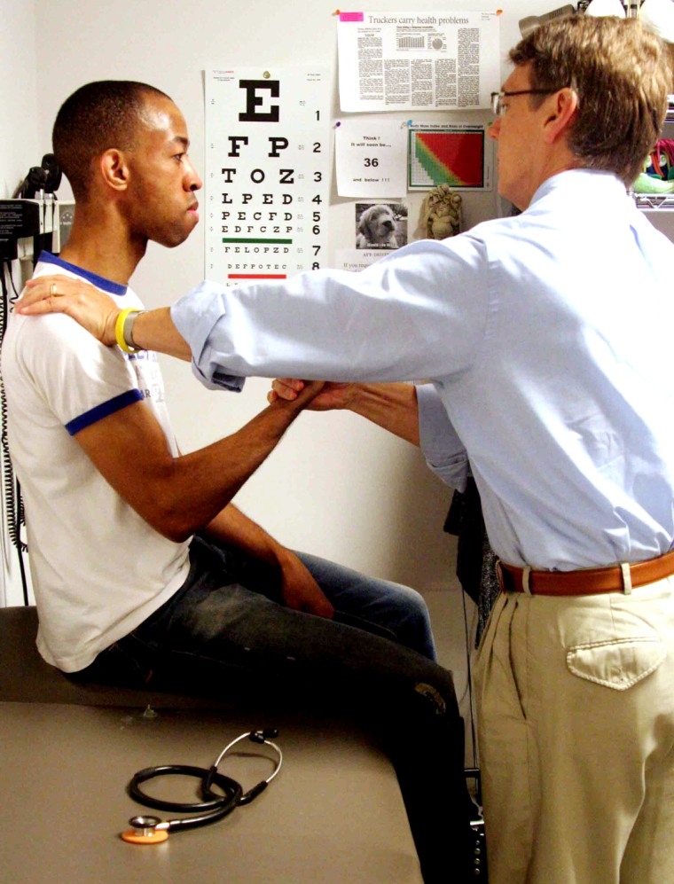 Rodney Blanks, left, a 29-year-old commercial van driver from Cleveland, Ohio, undergoes a Department of Transportation medical exam conducted by Dr. Richard O'Desky in Akron, Ohio. (Photo by Ryan Phillips/News21)