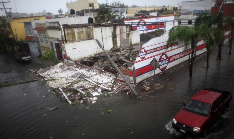 Image: A car passes a damaged warehouse after Hurricane Karl hit Veracruz