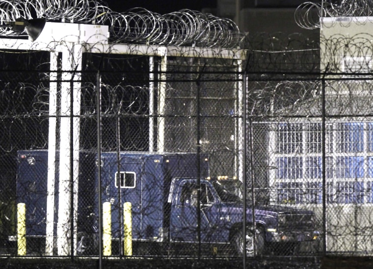 Image: A medical examiners truck leaves the Greensville Correctional Center