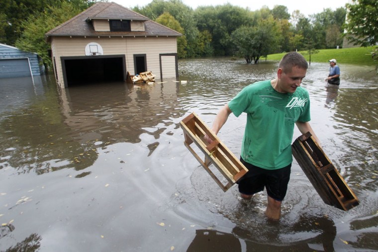 Image: Residents remove items from flooded homes