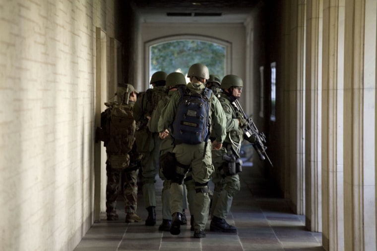 Image: Soldiers prepare to enter Calhoun Hall at the University of Texas in Austin.