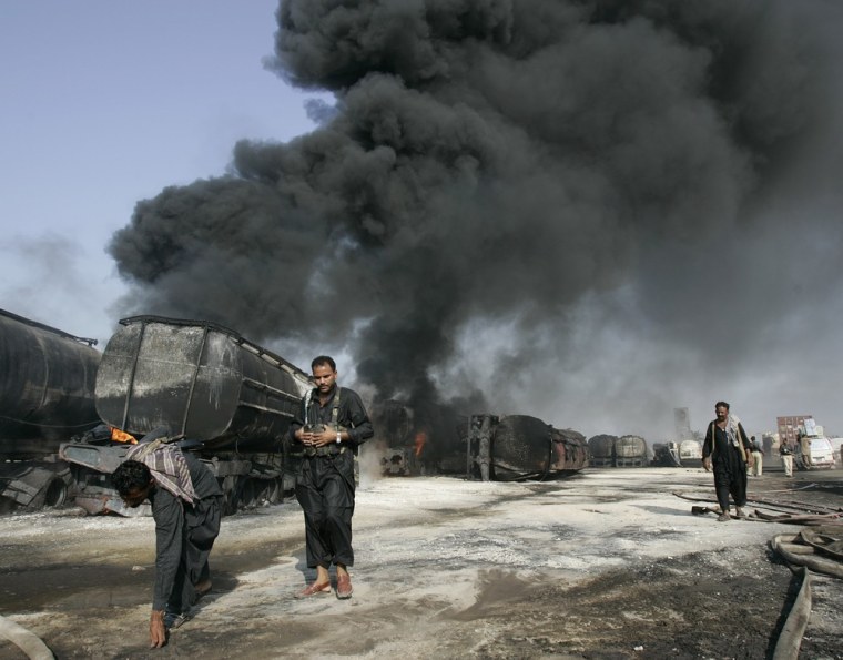Image: Smoldering NATO oil trucks attacked by militants in Pakistan