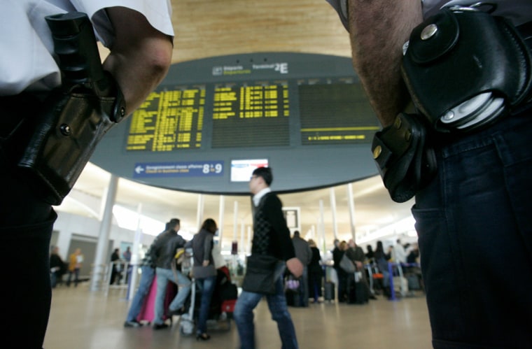 Image: French policemen stand guard at Airport Roissy Charles de Gaulle