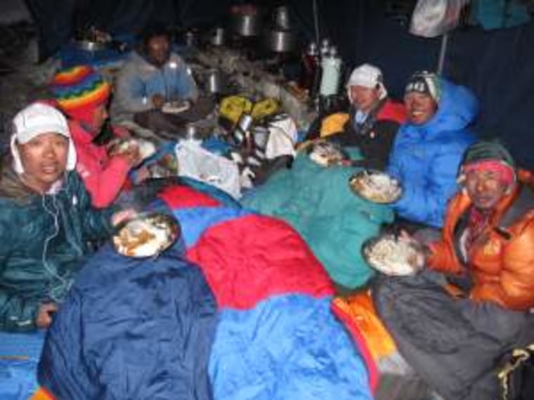 Eric Larsen's team having dinner among the sleeping bags.