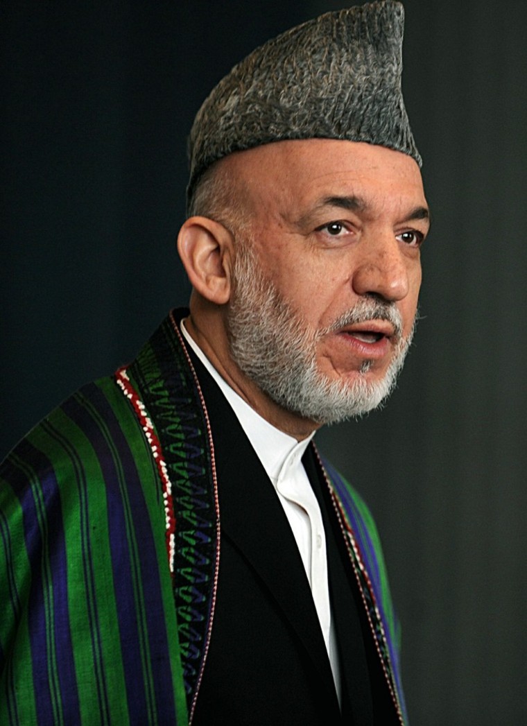 Image: Afghan President Hamid Karzai leaves a b