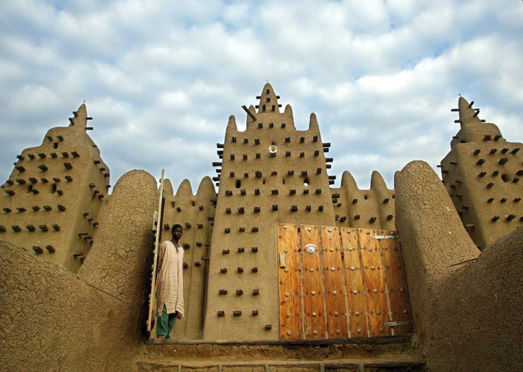 - PHOTO TAKEN 10AUG03 - A Malian walks out of the Great Mosque in Djenne, Mali August 10, 2003. The ..