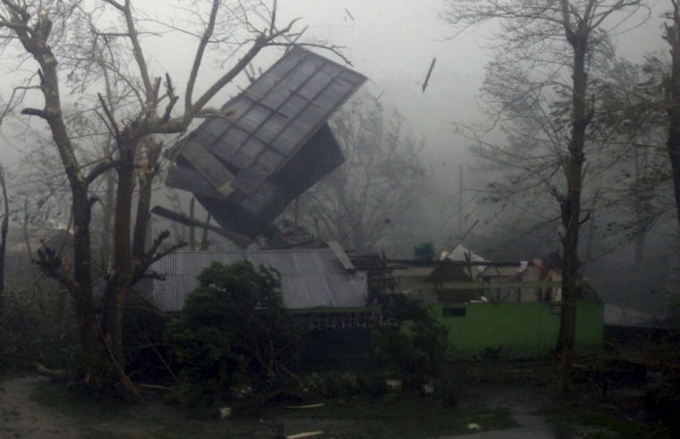 Image: The roof flies off a house as super typhoon Megi, known locally as Juan, hits Ilagan City, Isabela province, northern Philippines