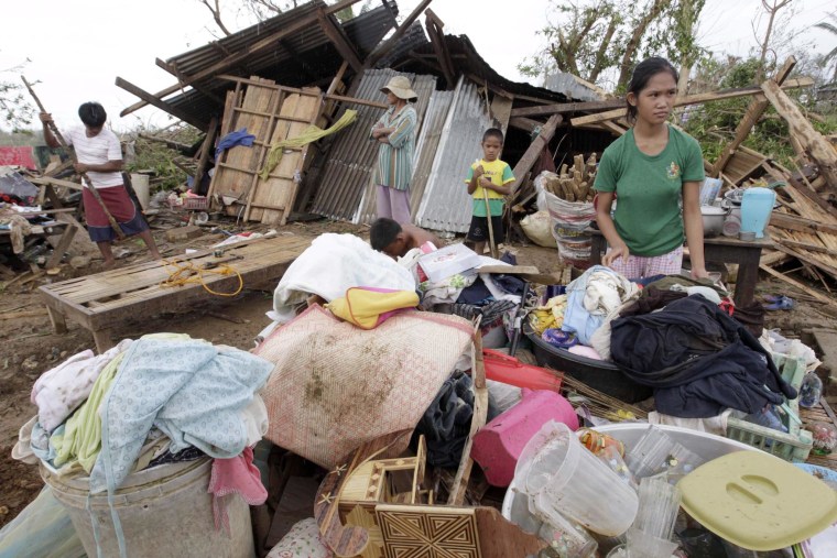 Image: Filipinos salvage their belongings after Typhoon Megi destroyed their house in Tumauini