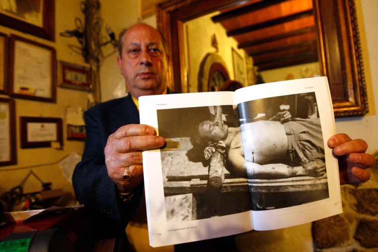 Image: Giuseppe Sciortino, nephew of the legendary Sicilian bandit Salvatore Giuliano, shows a picture of Giuliano's body in his house in Montelepre