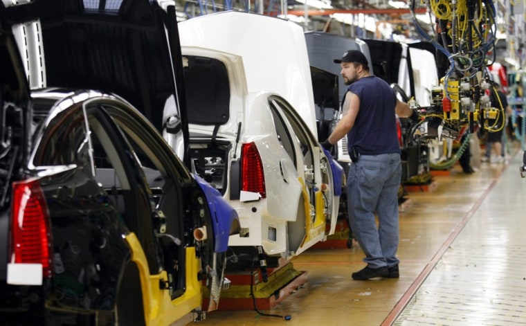 Image: A General Motors assembly worker works on the production line for the 2011 Cadillac at the Grand River Assembly plant in Lansing