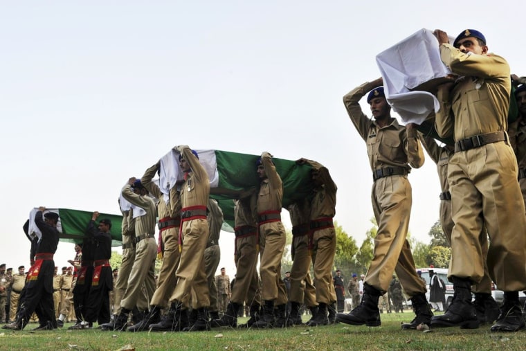 Image: Pakistani soldiers carry coffins of their colleagues during a funeral ceremony in Peshawar