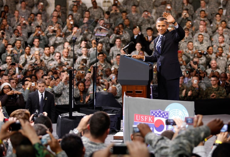 Image: U.S. President Barack Obama waves during a Veteran's Day event at the U.S. Army Garrison at Yongsan military base in Seoul