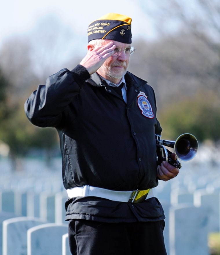 Image: Jim McGee, a member of the Fort Snelling Memorial Rifle Squad, salutes during a veteran's funeral at Fort Snelling National Cemetery
