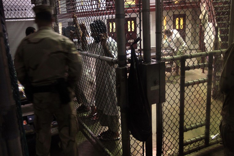 Image: Detainees gather to check out library books at Camp 6 in the Guantanamo Bay detention center
