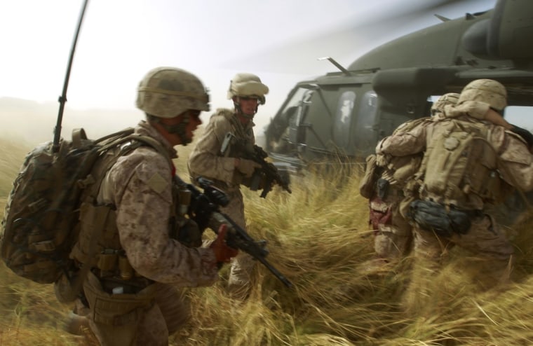 Image: U.S. Marines help their wounded comrade while under fire to a helicopter during a Medevac mission in southern Afghanistan's Helmand Province