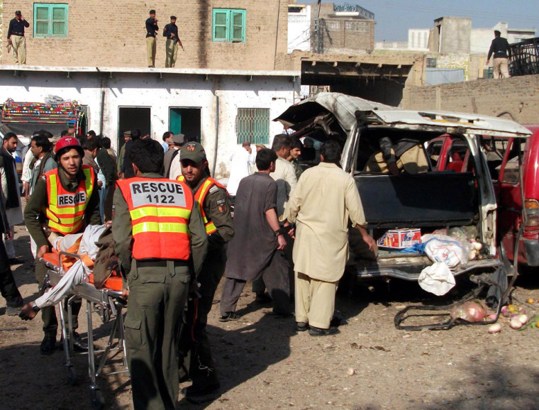 Image: Rescue workers rush injured victims of a suicide bomb attack to a hospital in Kohat, Pakistan