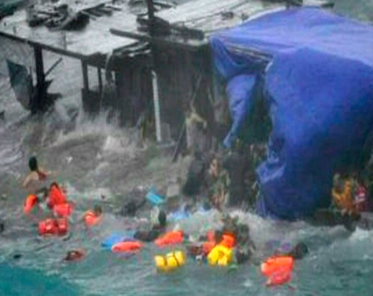 Image: A boat laden with refugees is driven onto rocks at Christmas Island in this still image taken from video