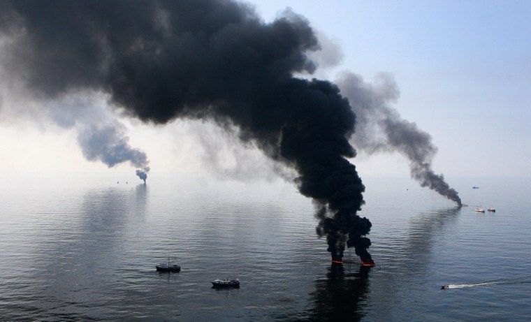 Image: Smoke billows from a controlled burn of spilled oil off the Louisiana coast in the Gulf of Mexico coast line