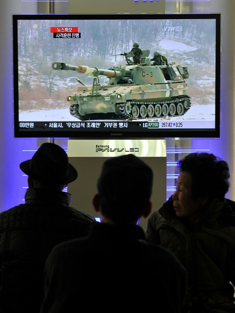 Image: South Koreans watch a live TV breaking news about South Korea's live fire artillery at Seoul train station in Seoul
