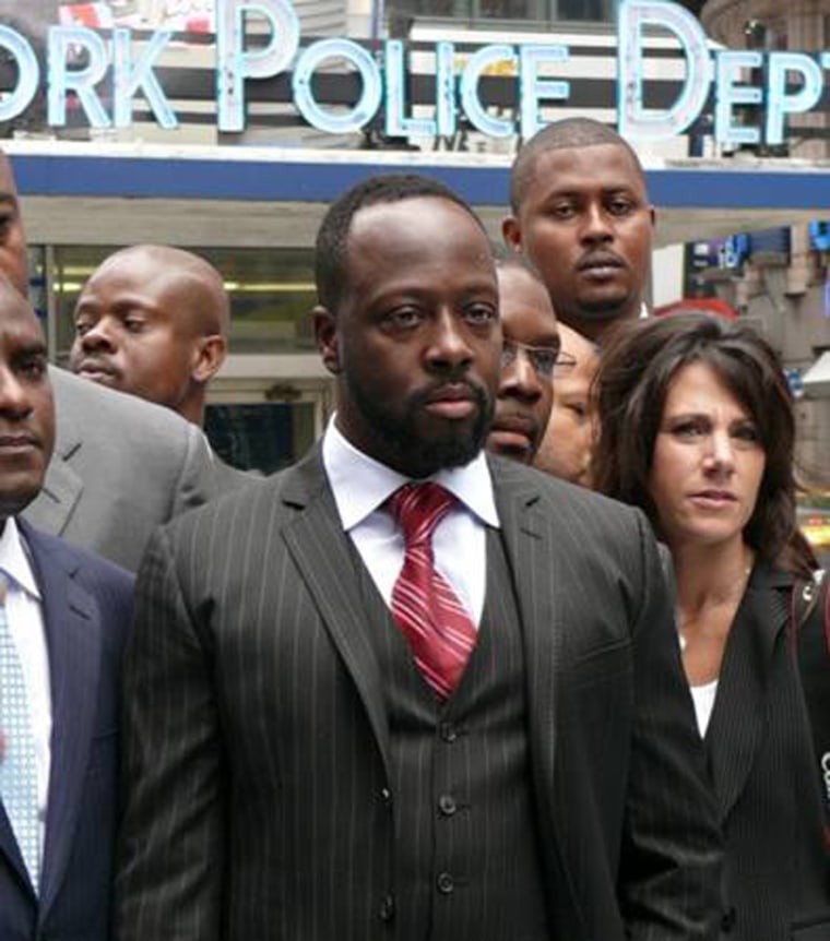 Wyclef Jean, outside of the Nasdaq building in Times Square next to fellow members of the Yéle Haiti Foundation, before he was honored at the Nasdaq opening bell ceremony on July 23, in wake of the six-month anniversary of the earthquake disaster in Haiti.