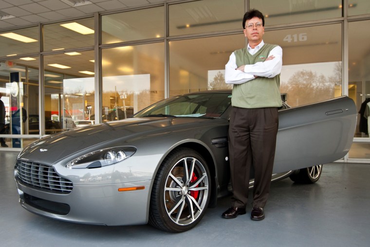 Image: General manager of Foreign Cars Italia Morell stands next to an Aston Martin at the dealership in Charlotte