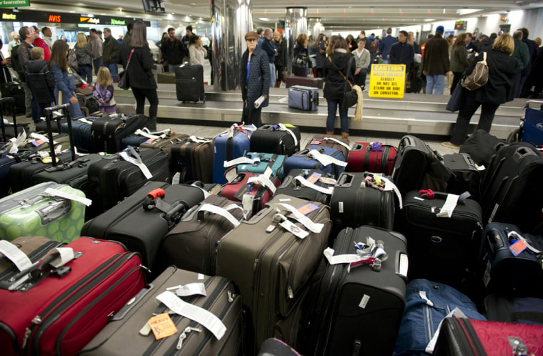 Image: Unclaimed bags in the foreground as trav