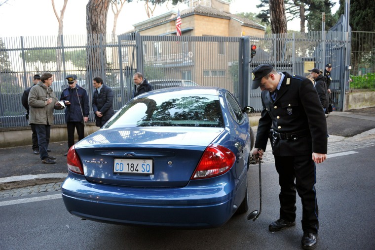 Image: A security member checks a car in front