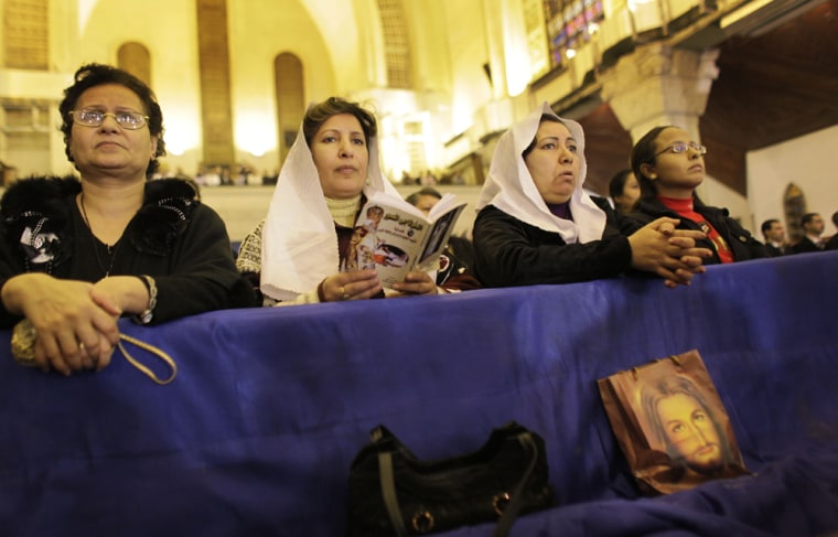 Image: Coptic Christian women attend Christmas Eve Mass at the Coptic cathedral in Cairo, Egypt